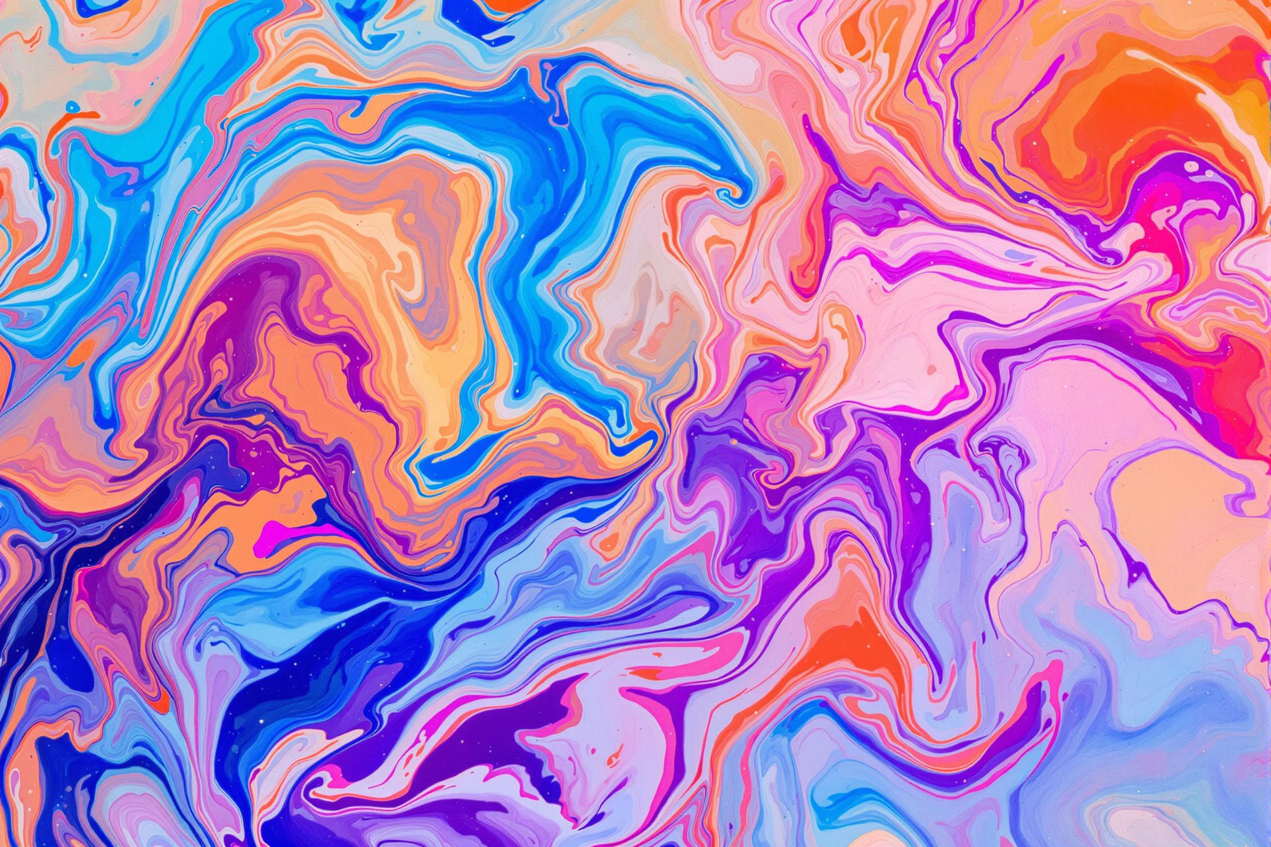 An abstract top-down view of swirling paint patterns blending seamlessly in water. Vivid hues of blue, orange, pink, and purple interact to form organic shapes and dynamic waves, enhanced by sparkling reflective particles in the liquid. Soft, diffused lighting amplifies vibrant contrasts while preserving fluid motion details.