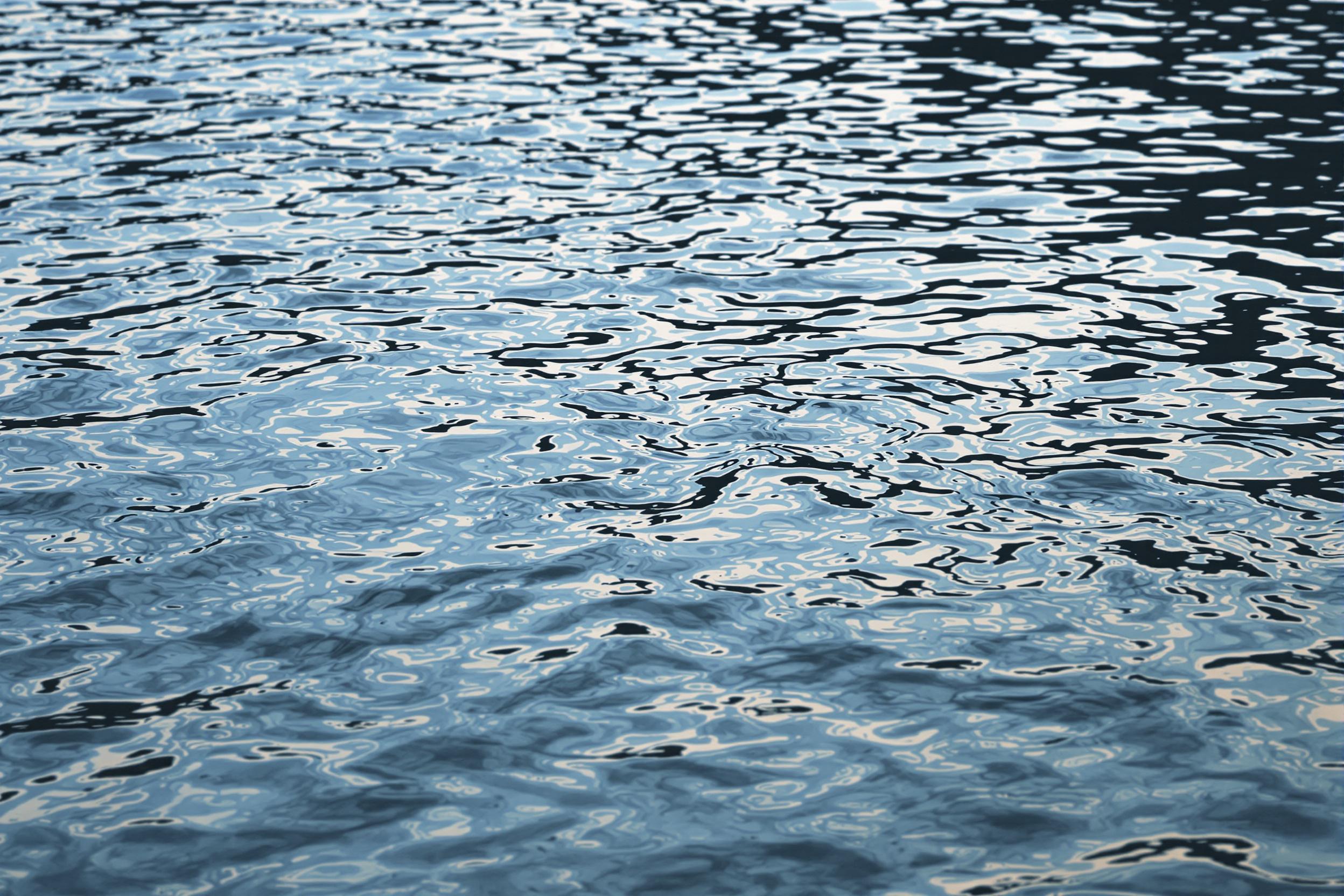 Explore the mesmerizing world of abstract water patterns in this captivating photograph. Gentle ripples create intricate, ever-changing designs on a tranquil water surface, reflecting soft light and subtle hues. This image showcases nature's artistry in fluid dynamics, offering a serene yet visually engaging composition perfect for themes of tranquility, change, and natural abstractions.