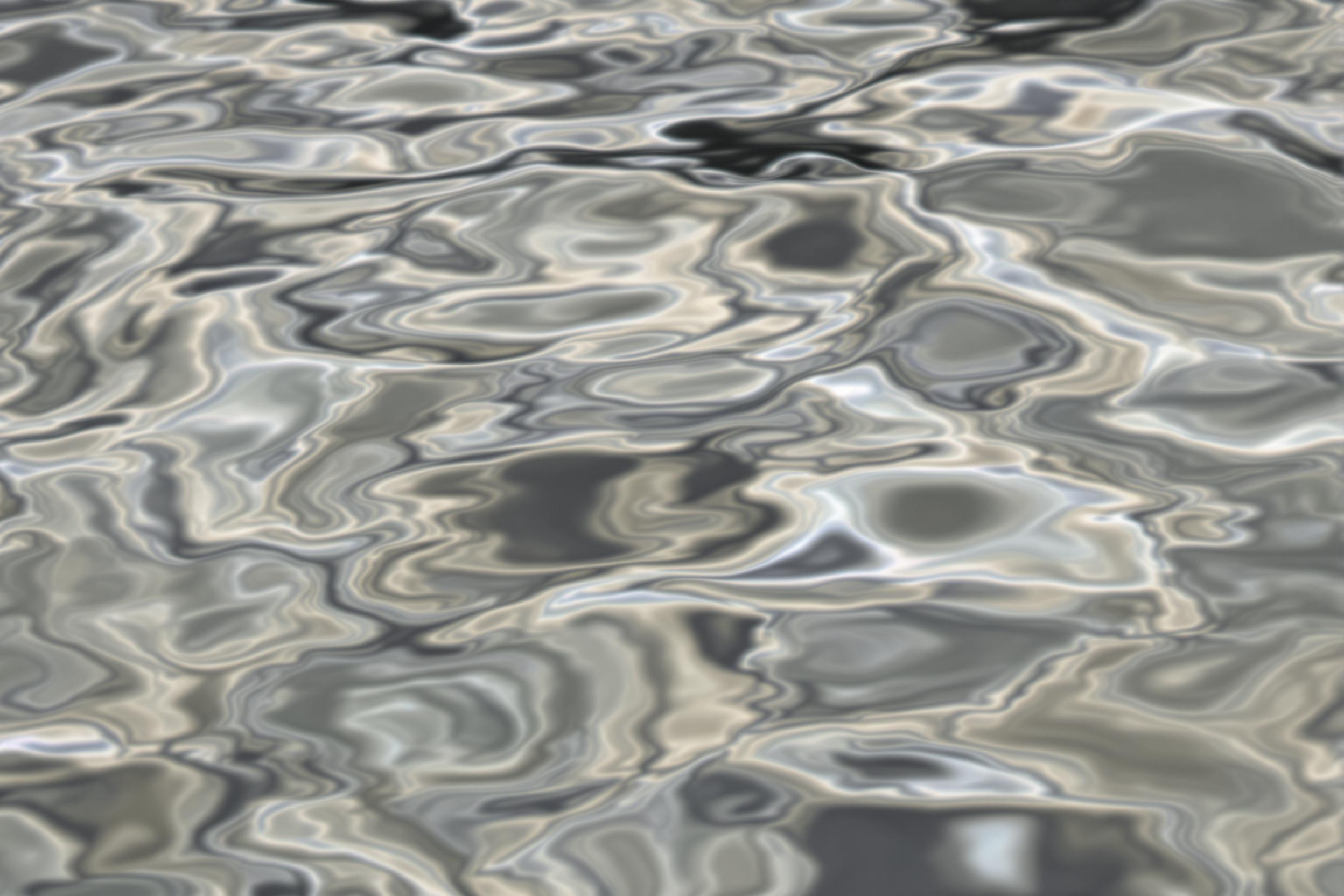 Explore the mesmerizing interplay of light and water in this abstract photograph. Gentle ripples create hypnotic patterns on a reflective surface, showcasing nature's artistic prowess in fluid dynamics.