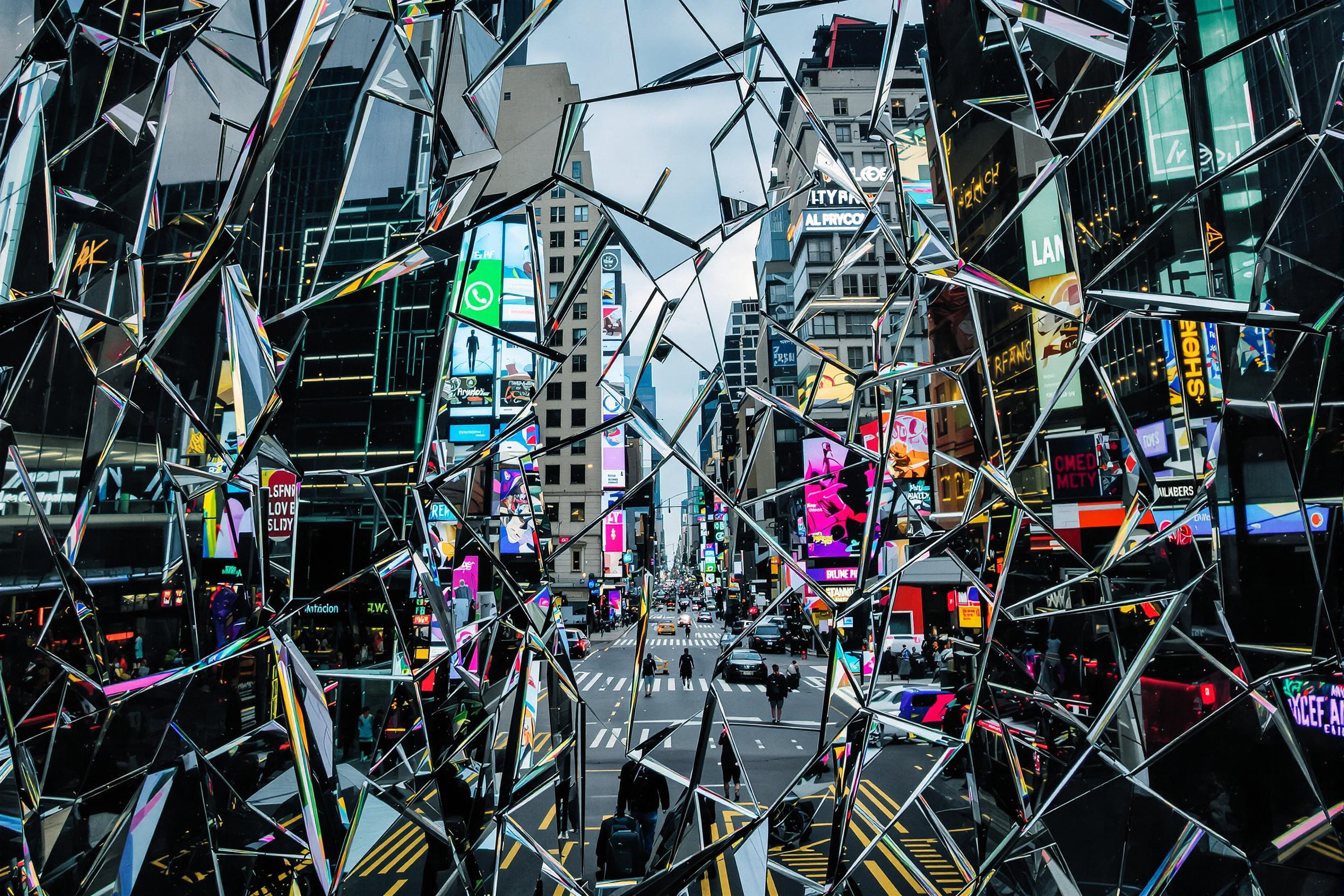 Abstract cityscape captured through fragmented glass, creating a mesmerizing kaleidoscope of urban life. Shattered reflections blend skyscrapers, neon lights, and bustling streets into a captivating geometric puzzle. A visual metaphor for the complexity of modern cities.