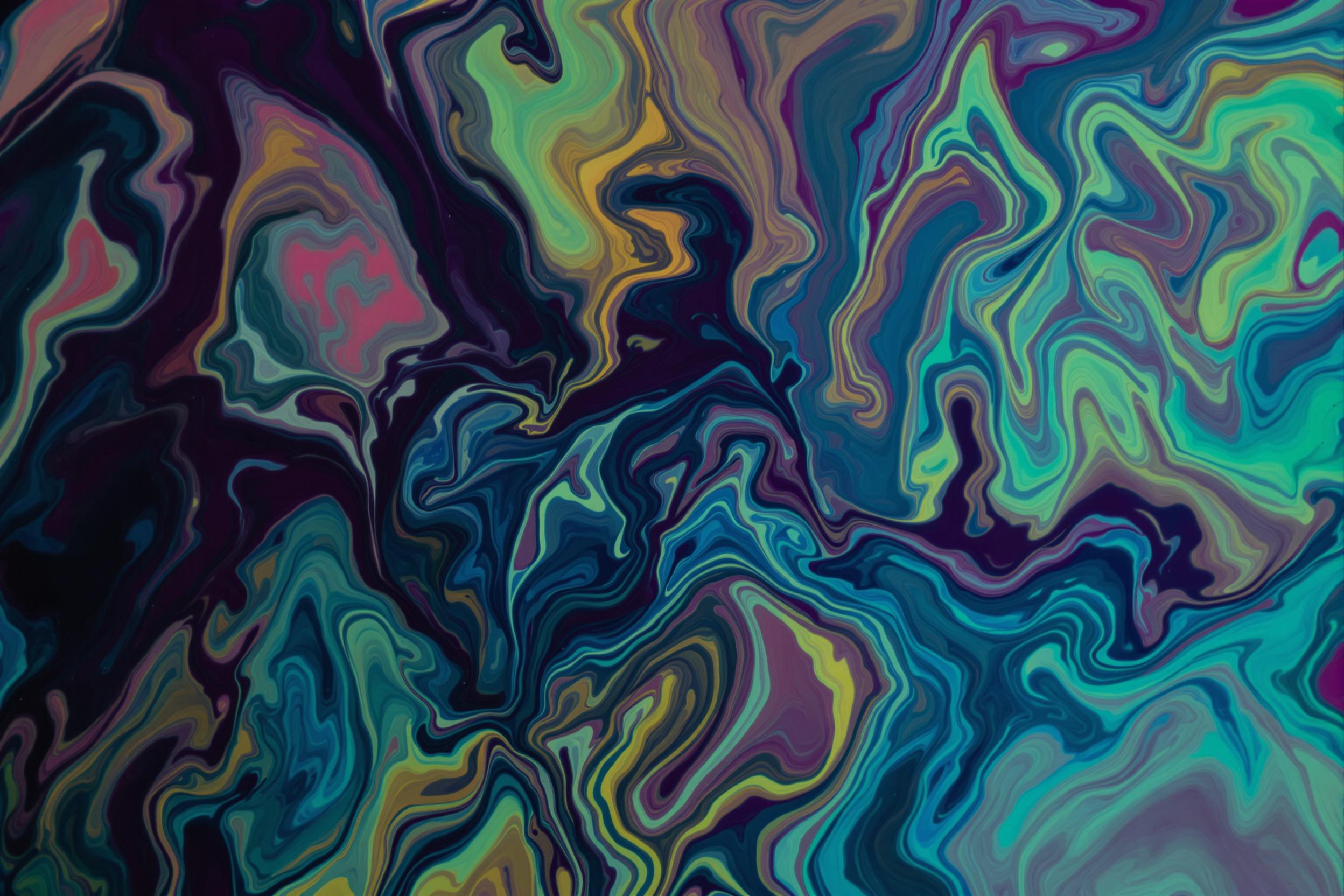 Mesmerizing abstract photograph capturing the fluid dance of vibrant pigments in water. Swirling tendrils of rich colors intertwine, creating a liquid marble effect. This image showcases the beauty of fluid dynamics and color theory in a captivating, organic composition.