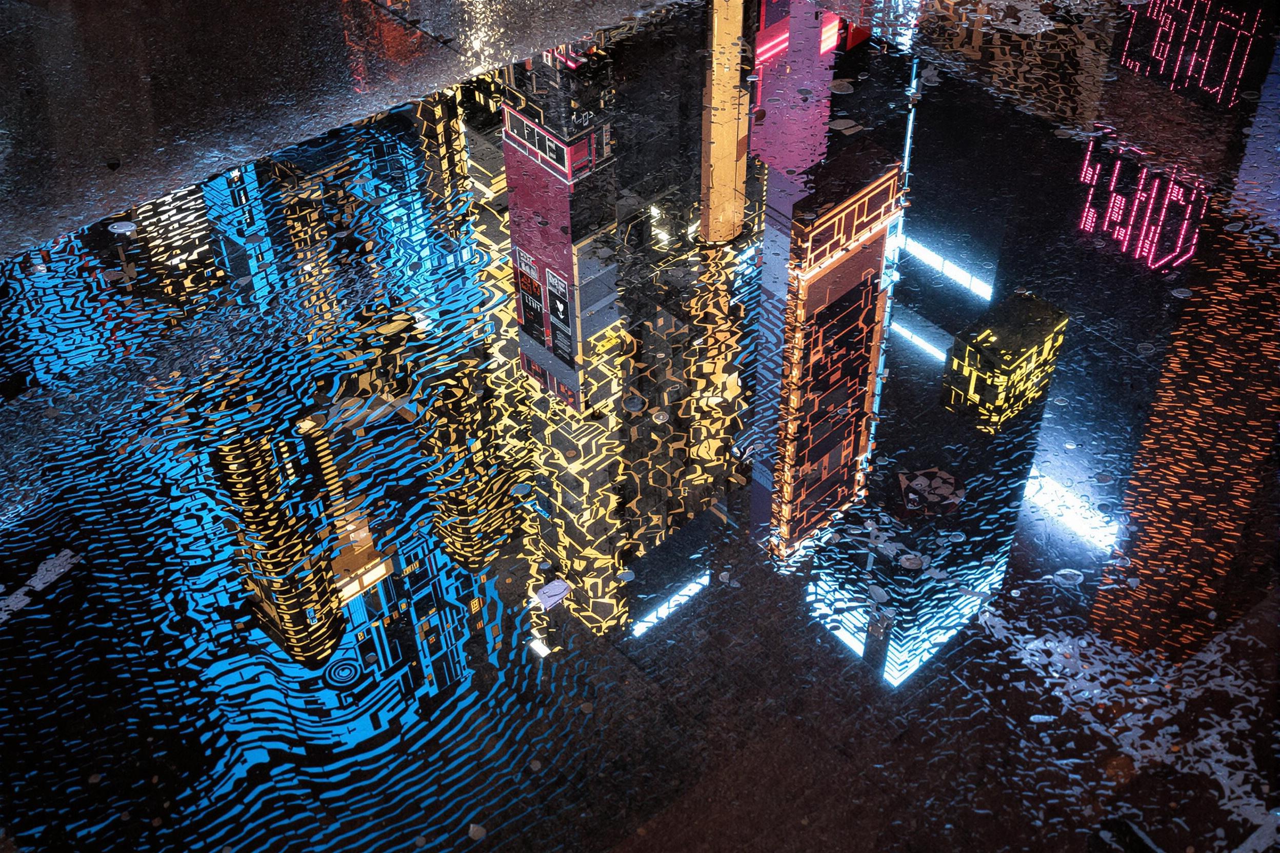 Discover the enchanting world of urban abstractions in this mesmerizing photograph. A rain-soaked street transforms into a canvas of shimmering reflections, creating a dreamlike cityscape within a puddle. Inverted skyscrapers and neon lights dance in rippled water, blurring the line between reality and illusion.