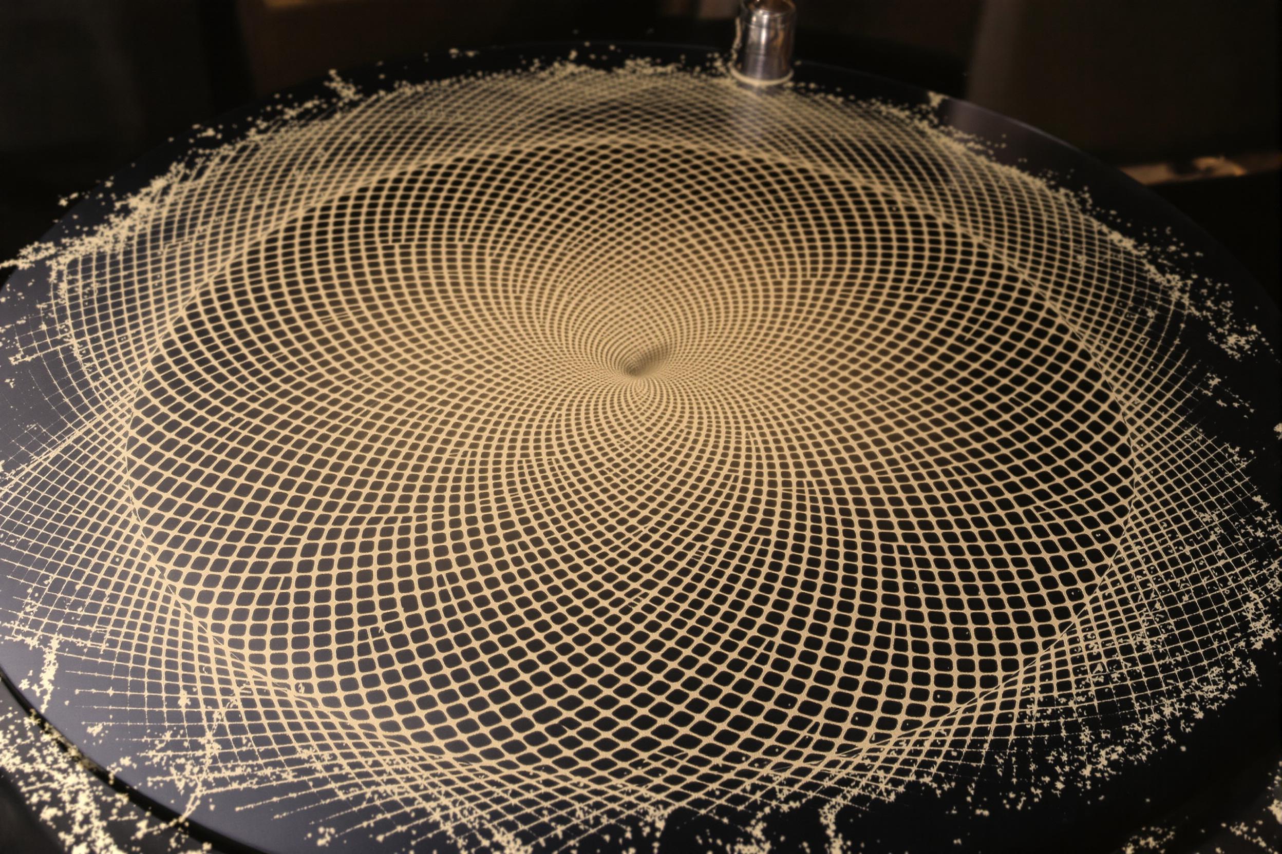 Explore the fascinating world of cymatics in this experimental photograph. Intricate geometric patterns form in fine sand on a vibrating plate, visualizing different sound frequencies. A mesmerizing blend of science and art.