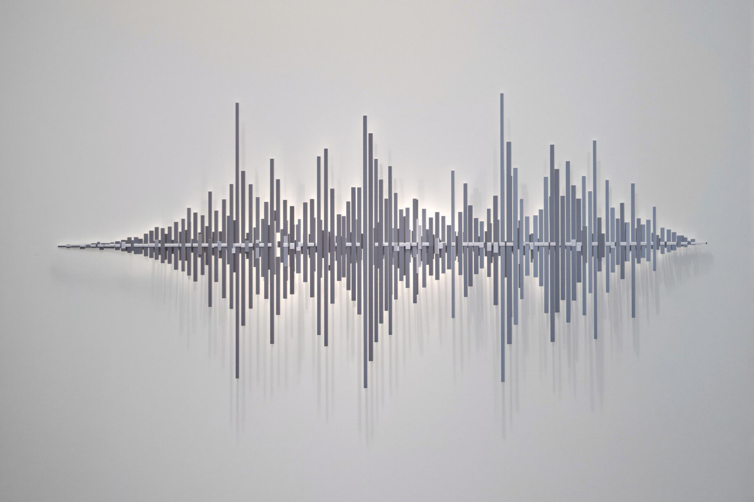 Discover the intersection of sound and sculpture in this innovative experimental photograph. A 3D-printed soundwave captures a musician's voice, creating a tangible representation of audio frequencies against a stark white background.