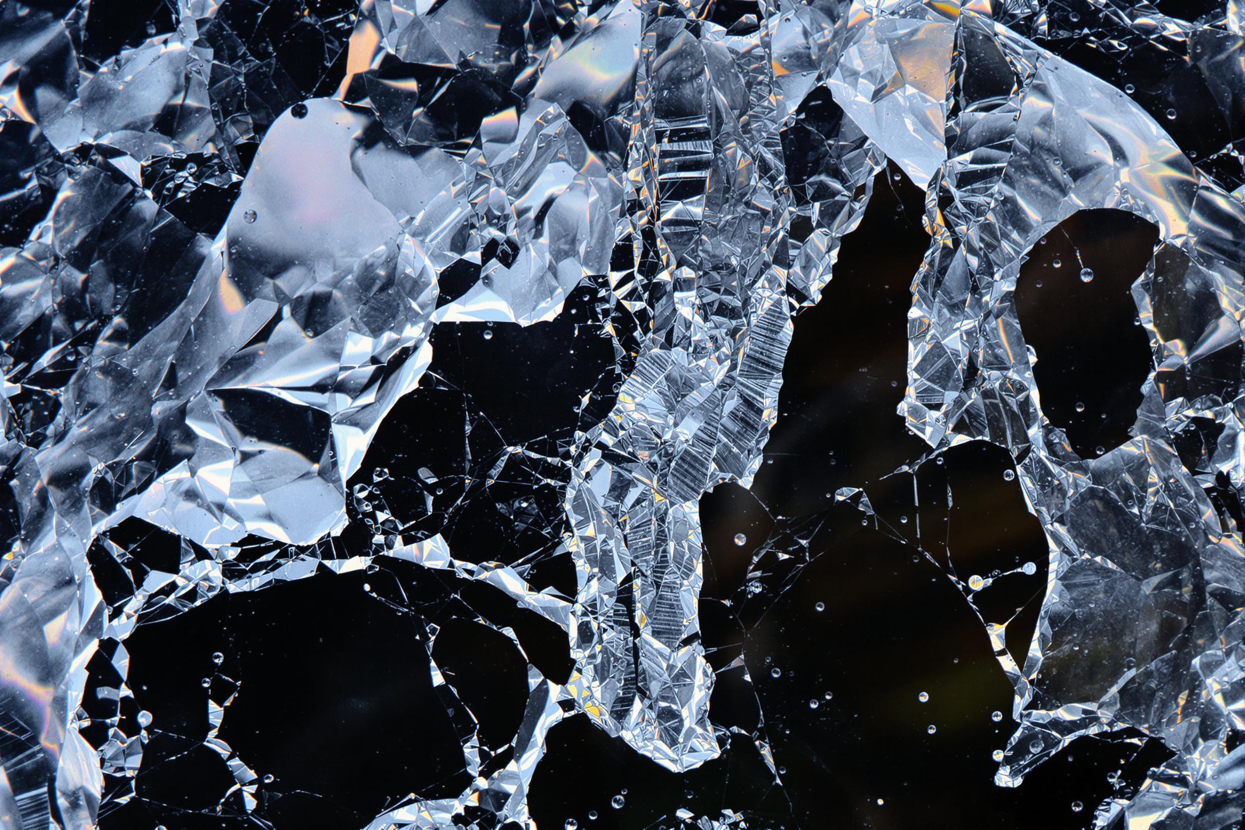 Capture the transient beauty of a naturally formed ice sculpture, showcasing intricate patterns and delicate structures. This experimental photograph highlights the interplay of light, texture, and form in a rapidly melting ice formation, emphasizing nature's fleeting artistry.