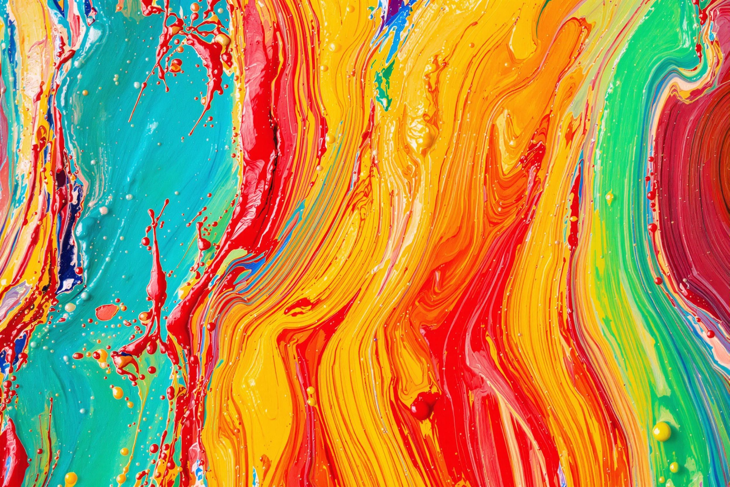 Vivid oil paint brushstrokes captured in macro reveal intense textures. Lush applications blend bold reds and yellows against softer tones of blue and green, creating swirling patterns. Diffused natural lighting illuminates glistening ridges and smooth transitions between colors, emphasizing handcrafted artistry.