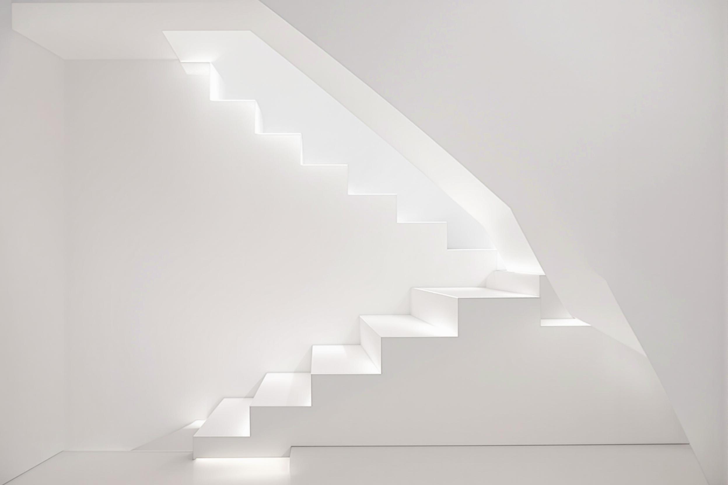 A mesmerizing minimalist staircase with floating white steps against a stark white wall. The architectural marvel creates an illusion of weightlessness, emphasizing clean lines and geometric precision in interior design.