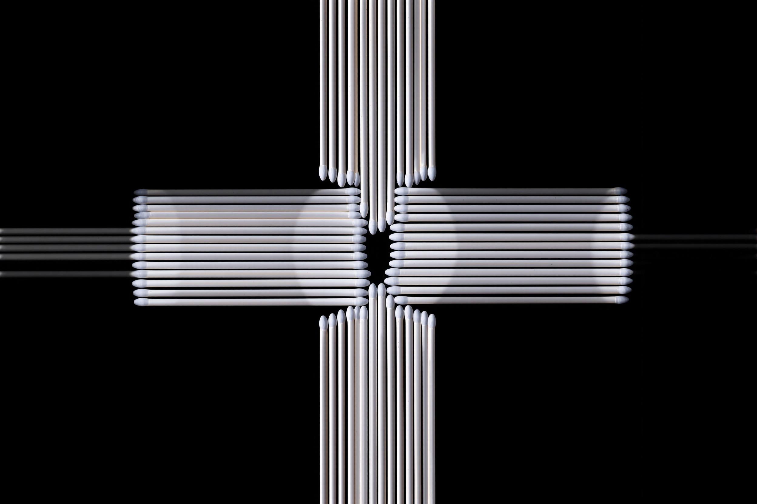 A striking minimalist composition featuring a precise arrangement of white matchsticks against a contrasting black background. The image showcases perfect symmetry, clean lines, and a powerful interplay of light and shadow, embodying the essence of minimalist design.