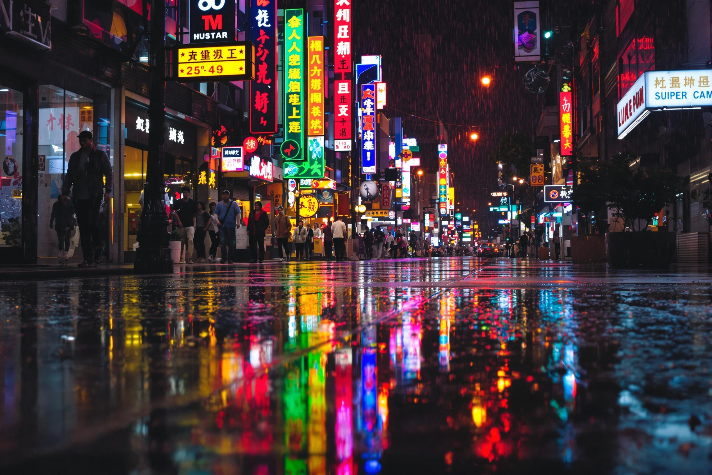 Explore the vibrant nightlife of a bustling city through its rain-soaked streets. Neon signs and streetlights create a kaleidoscope of colors reflected in puddles, offering a unique perspective on urban nighttime photography.