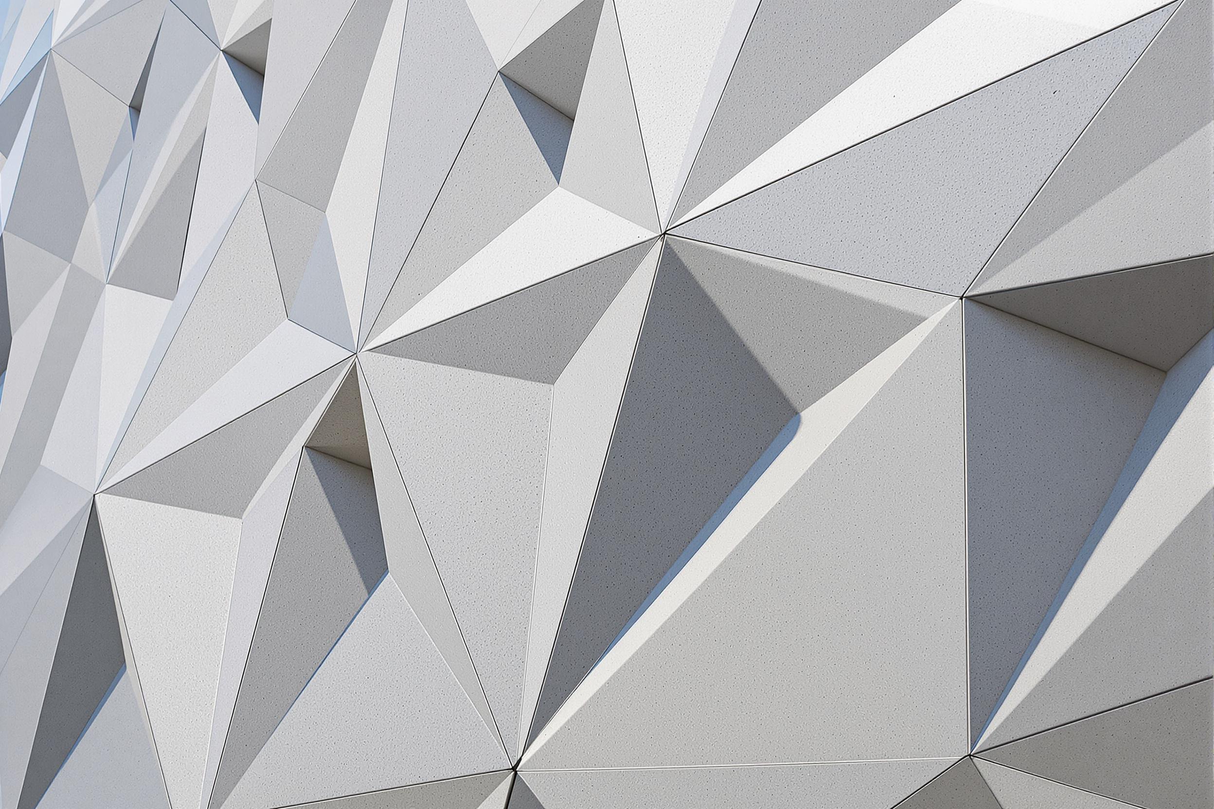 Explore the captivating interplay of light and shadow on a modern building's intricate geometric patterns. This image showcases a close-up of textured surfaces, highlighting the contrast between smooth and rough elements. Ideal for architecture and design themes, it captures the essence of contemporary urban aesthetics.