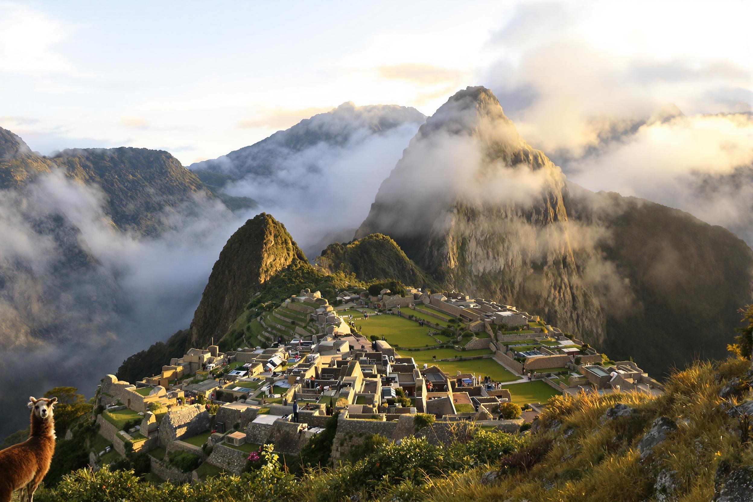 Witness the awe-inspiring beauty of Machu Picchu at dawn. Golden sunlight bathes the ancient Incan citadel, illuminating mist-shrouded peaks and terraced stone structures. A llama grazes peacefully in the foreground, adding local charm to this UNESCO World Heritage site.