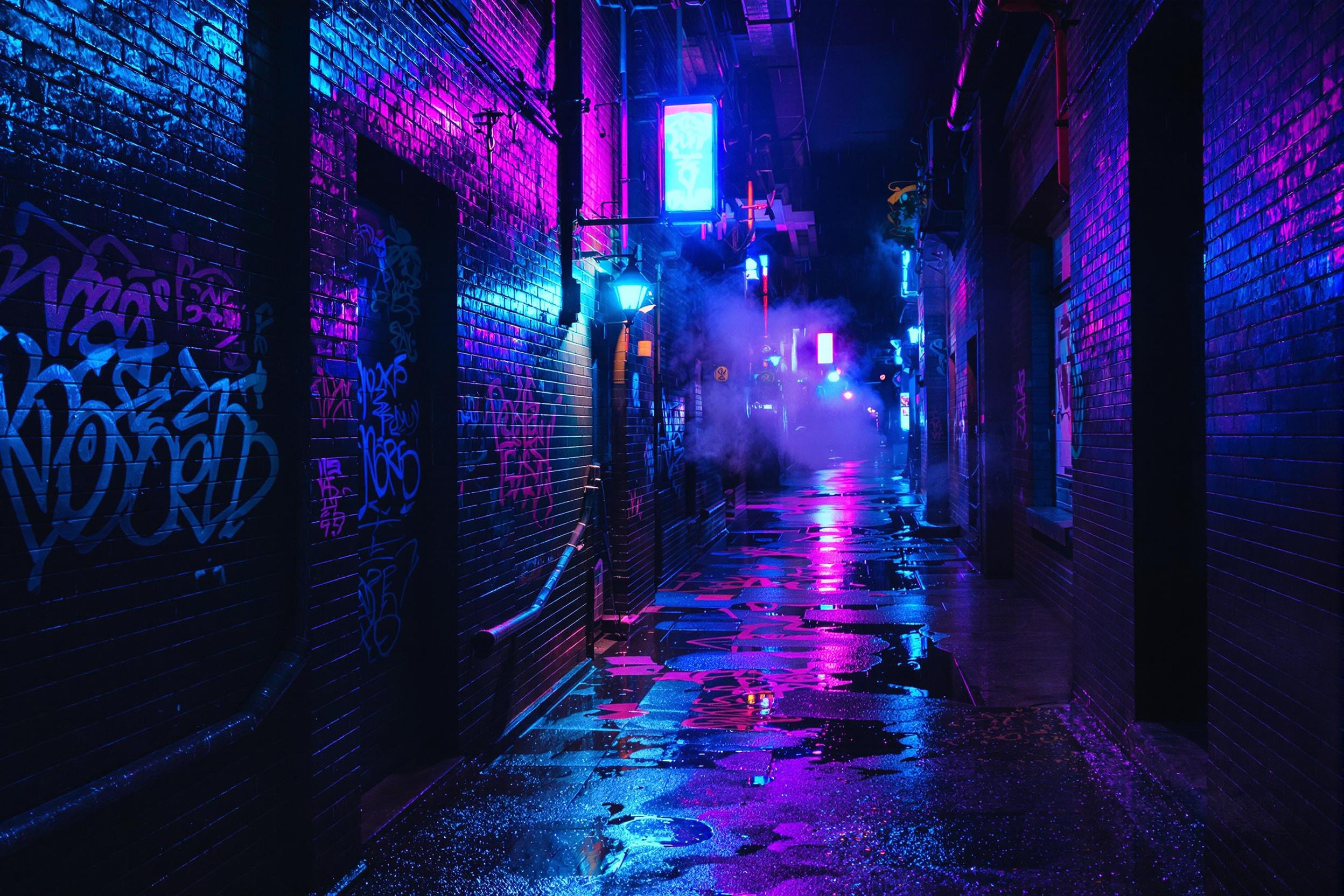 A slick urban alleyway glimmers under bright neon lights in shades of blue, purple, and pink on a rainy night. Reflections ripple across water-filled puddles on the concrete path. Graffiti tags are faintly visible on brick walls, and wisps of steam rise from vents, enhancing the cinematic vibe.