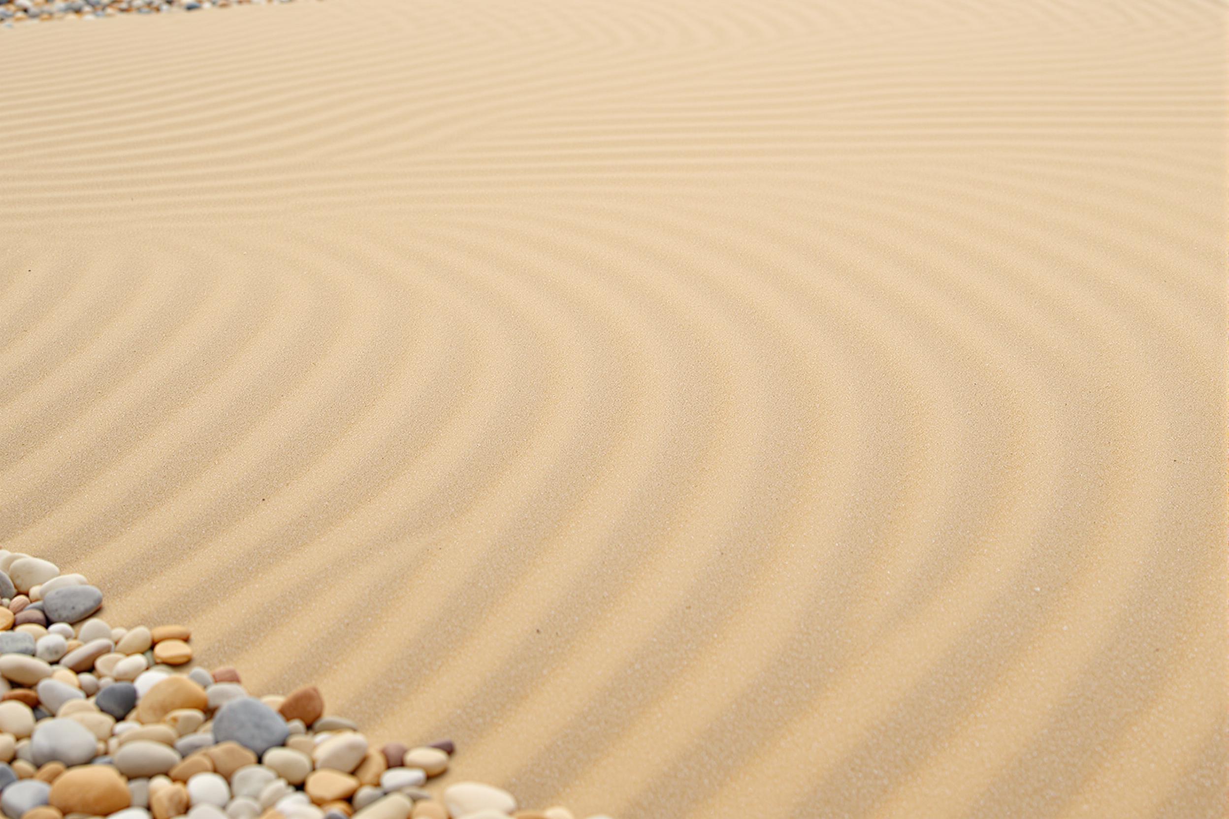 Experience tranquility with this high-resolution wallpaper of a meticulously raked zen garden. Smooth pebbles and precise sand patterns create a harmonious composition, offering a serene and minimalist backdrop for any device screen.